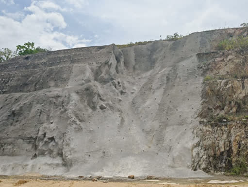 Stabilized rock face with engineered system